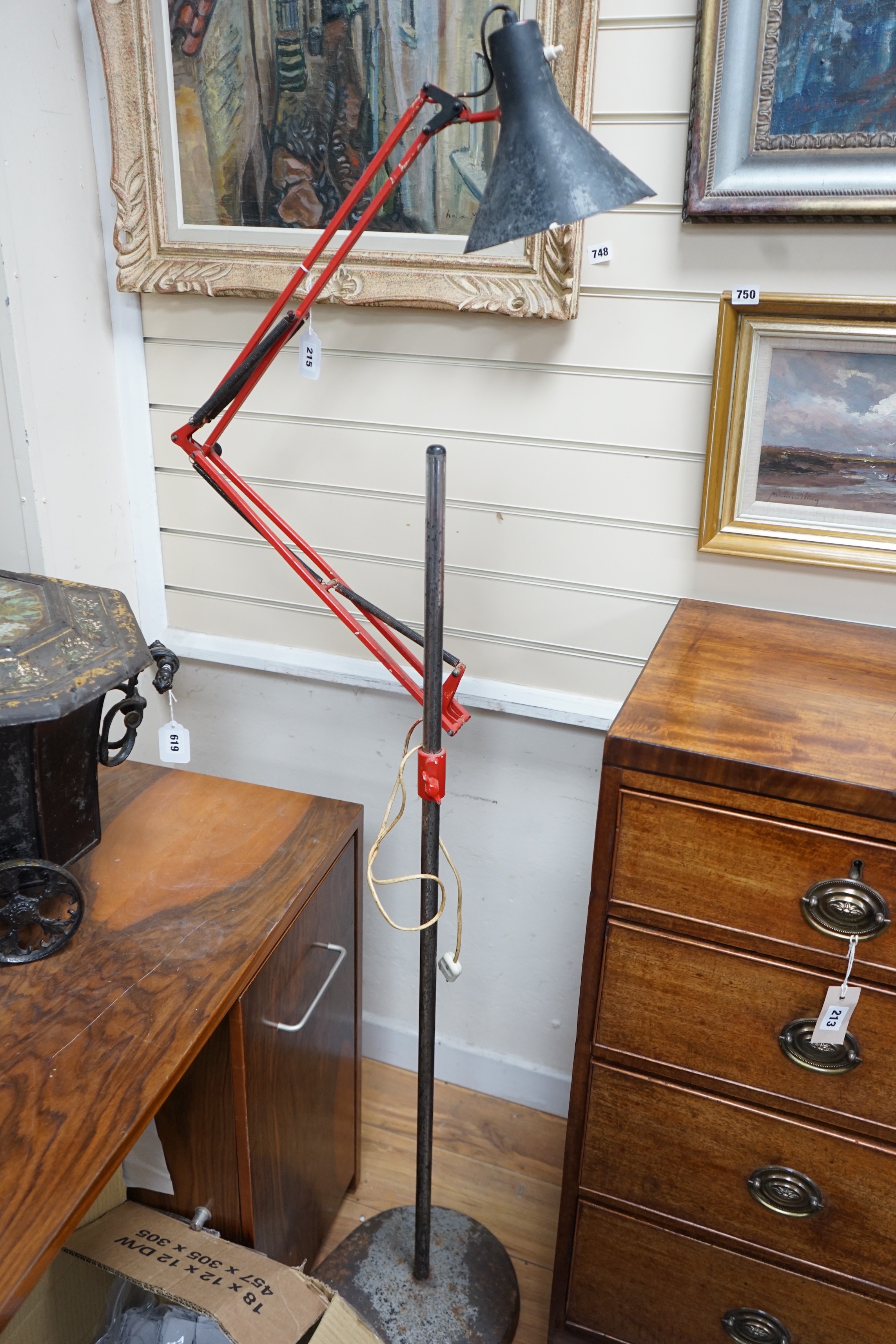 A converted industrial style anglepoise standard lamp on cast metal wheeled stand